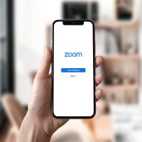 Hand holding Phone with Zoom error
