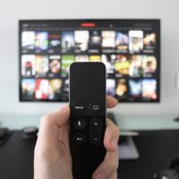 Remote control with TV in the background