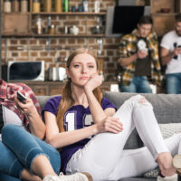 Two women watching TV upset